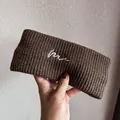 Detail of coffee brown knitted elastic headband with white cursive letter embroidery - Coffee