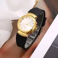 Detail of quartz watch featuring golden case, rhinestone dial, and black silicone strap - White Face Black Strap