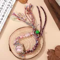 Bohemian woven strap watch with rhinestone bezel and beaded tassel on wood background - Pink