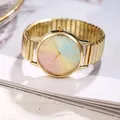 Macro view of gold metal elastic strap and macaron gradient dial on student watch - Gold