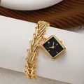 Detail of the golden chain strap and black square dial of the women watch - Black