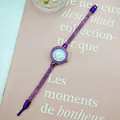Detailed macro view of purple mesh strap watch with sparkling rhinestone bezel - Purple
