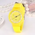 Close-up of vibrant yellow quartz watch with silicone strap and elegant accessories - Yellow