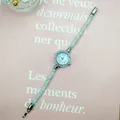 Macro view of crystal-filled mesh watch strap with sparkling silver rhinestone details - White