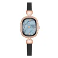 Macro detail of oval rose gold watch with sparkling crystals and marble blue dial - Shell Roman Black