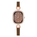 Detailed view of an oval rose gold watch with crystal bezel and brown leather strap - Numeral Brown