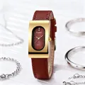 Detail of vintage rectangular gold watch with dark red dial and brown leather strap - Gold Case Red Dial Red Strap