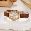 Detail of luxury gold watch with diamond bezel, colorful mother of pearl dial and leather strap - Coffee