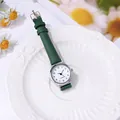 Close-up of women's quartz watch with green leather strap and daisy floral accents - Print Green