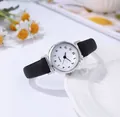 Close-up of minimalist women's quartz watch with black leather strap and white dial - Print Black