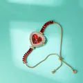 Detail of red heart watch with zircon bezel and gold-tone pull-clasp chain bracelet - Golden Red