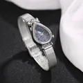 Macro view of teardrop quartz watch with diamond bezel and silver mesh band detail - Number Black