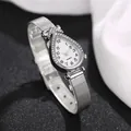 Detailed close-up of a silver teardrop watch with diamond-set bezel and mesh strap - Numeral White