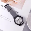 Detail of quartz watch with grey silicone strap and white three-eye dial on a table - Gray