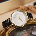 Detailed macro shot of a golden bow-tie relief on a white dial women quartz watch - Black