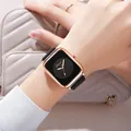 Close-up of minimalist square rose gold watch with black silicone strap on a female wrist - Black Face Black Strap