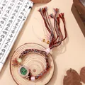 Ethnic style quartz watch with green oval dial, woven colorful strap and tassel detail - Green