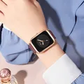 Detail of elegant square rose gold watch with black dial and burgundy strap on wrist - Black Dial Wine Red Strap