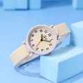 Close-up of pink quartz watch for girls with cream silicone strap on blue background - Beige Silicone Strap