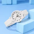 Macro view of minimalist white quartz watch with black numerals and silicone strap - White Silicone Strap