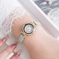 Close-up of a mint green leather strap watch with rhinestone bezel on a woman's wrist - Light Green
