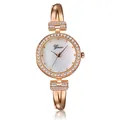 Detail view of rose gold women bracelet watch with pearl dial and sparkling crystals - Rose Gold White