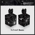 Detail of 6 Halloween treat boxes featuring black spider web and bat patterns - Apple Box Style