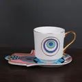Ceramic coffee cup with Hamsa-shaped saucer featuring blue ethnic patterns and gold handle - Pink And Blue Hamsa Hand (ZH0563)