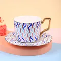 Ceramic coffee cup set with red and blue geometric patterns and gold handle - Cup And Saucer Cfbd0066 / Approximately 250ml