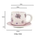 Macro view of ceramic coffee cup with floral patterns and technical dimensions - Violet