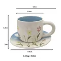 Floral ceramic coffee cup and saucer set in white with pink flowers and 250ml capacity - Hand-pinched Blue Illustration