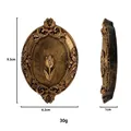Detailed view of vintage gold oval plaque with embossed tulip and classical scroll patterns - Incense Tray / Style B