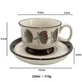 Ceramic coffee cup and saucer set with hand-painted green floral patterns and brown trim - Brown