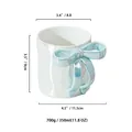 White ceramic mug with light blue 3D bow handle and iridescent pearlescent finish - Blue