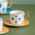 Tazza da caffè in ceramica con motivo malocchio e manico geometrico dorato elegante - Motivo Cuore Malocchio