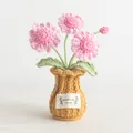 Handmade crochet pink daisy flower pot with a yellow knitted base and woven leaves - Pink Daisy