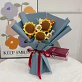 Detail of handmade crochet sunflower bouquet with blue paper and red silk ribbon - Sunflower-Blue Series