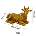 Statua di toro dorato in resina con dimensioni 12,2x6x7,7cm e peso 130g - Mucca Dorata (MCD-014)