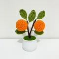 Handmade crochet orange potted plant with green leaves in a white ceramic pot - Orange Style