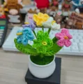 Handmade knitted colorful flower pot decor with six mixed crochet forget-me-not blooms - Colorful