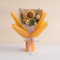 Detailansicht eines handgestrickten Sonnenblumenstraußes in gelber Geschenkverpackung - Gold