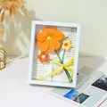 Flores de ganchillo naranjas hechas a mano en marco 3D blanco con lazo de cuadros - Marco de Fotos de Flores Cosmos - Naranja (Terminado)