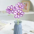 Three handmade crochet purple and white daisies in a blue geometric vase for home decor - Gradient Deep Purple