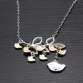 Detail shot of a branch-shaped pendant with seven gold and one silver bird charms - Seven Birds Style (XL121-7)