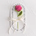 Detailed view of hand-knitted rose on display card with Love Is Eternal ribbon decoration - New Rose Crochet Flower (Rose Red Handbag) / Rose Red