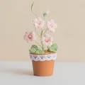 Handmade crochet pink freesia potted flower with white lace trim on a terracotta pot - Light Pink