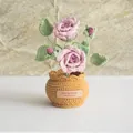 Detail of handmade crochet pink rose potted plant with a yellow knitted pot and leather tag - Double Headed Rose Light Pink