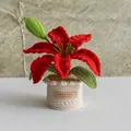 Handmade crochet red lily potted plant with green leaves and a beige knit pot base - Lily Red