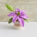 Macro detail of handmade crochet lily with purple petals and brown leather label - Lily Purple