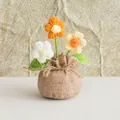 Detalle de planta de flores de ganchillo hechas a mano con base envuelta en arpillera - Flor de Soplo de Bolsa de la Suerte Amarilla / Amarillo